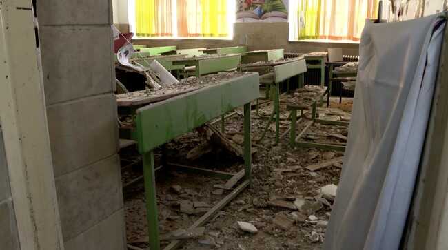 Poignant photographs show a primary school classroom bombed by the US–Israel, with many images of children