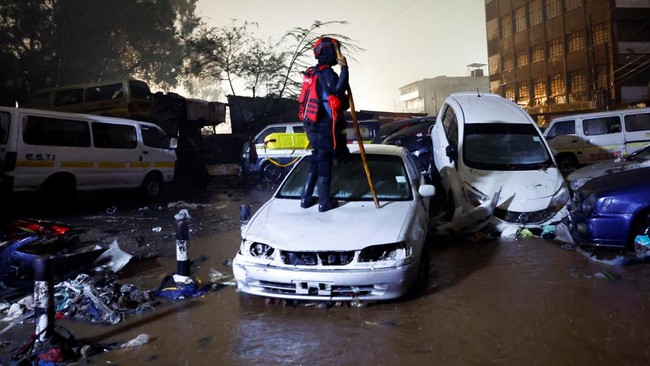 Flash floods sweep away cars as egg seller dies after being crushed beneath a vehicle