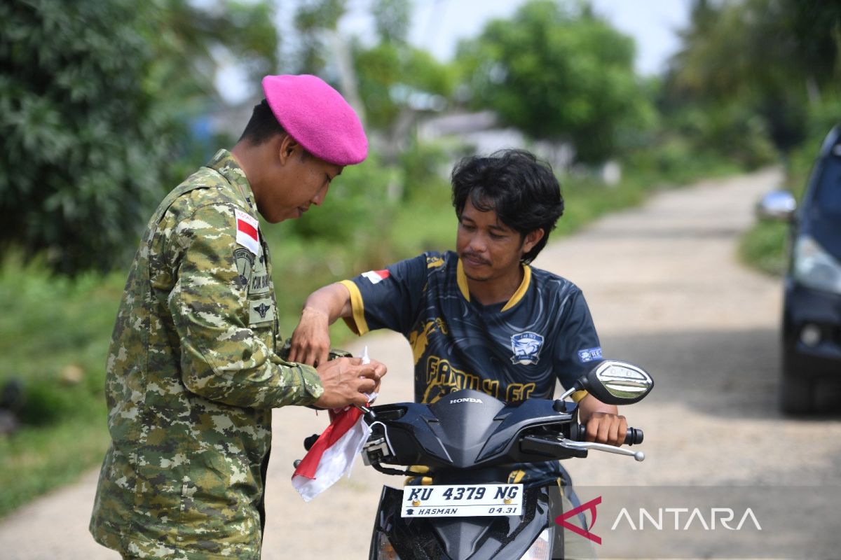 Marines distribute flags on Sebatik Island ahead of 81st Independence Day
